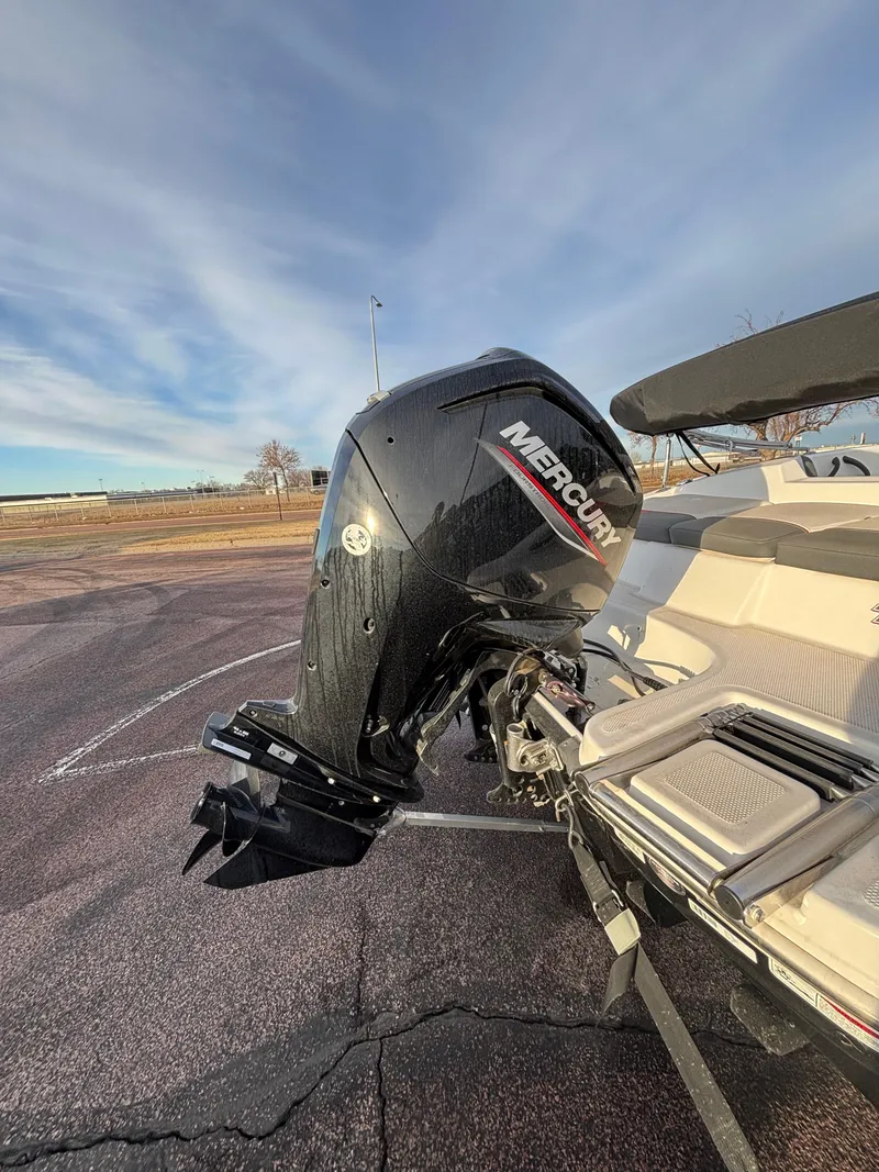Slide: The Image of 2023 Tahoe T16 boat with Mercury outboard motor in a parking lot. - 8