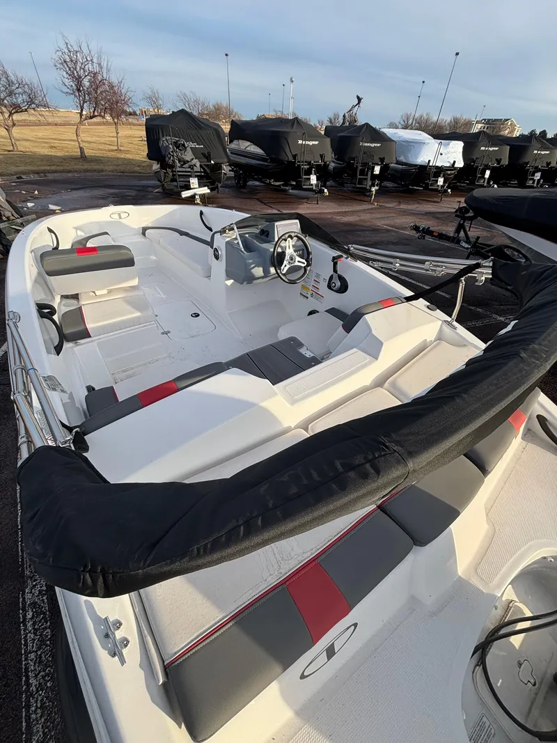 Slide: The Image of 2023 Tahoe T16 boat with sleek design, docked outdoors. - 9