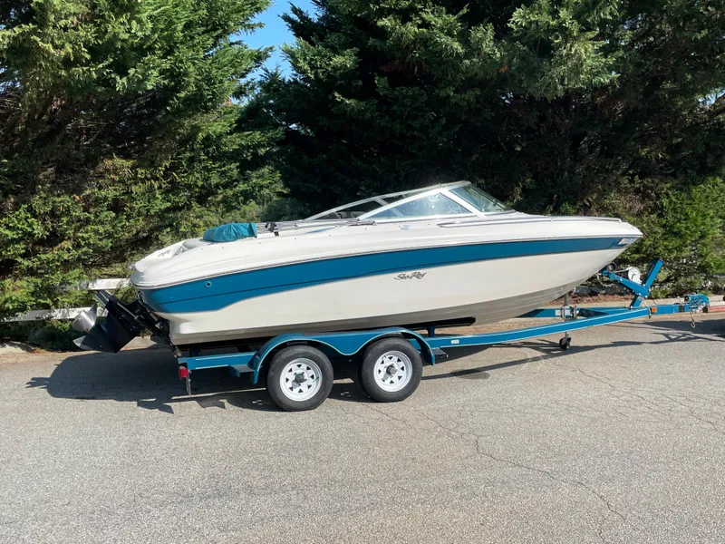 Slide: The Image of 1997 Sea Ray 190 SIGNATURE boat on trailer, parked outdoors. - 1