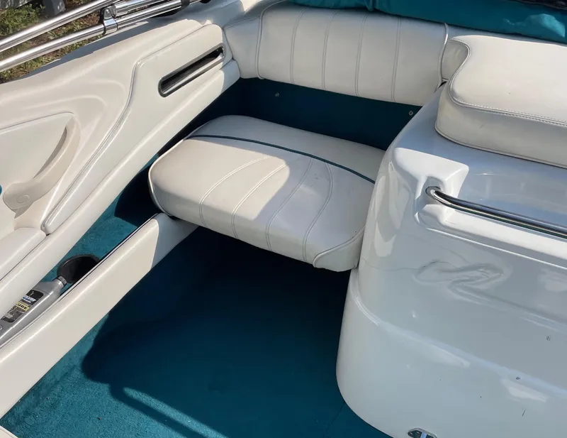 Slide: The Image of 1997 Sea Ray 190 Signature boat interior with white seating and blue carpet. - 18