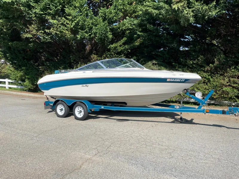 Slide: The Image of 1997 Sea Ray 190 Signature boat on trailer, parked outdoors. - 2
