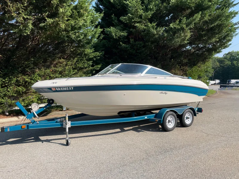 Slide: The Image of 1997 Sea Ray 190 Signature boat on trailer, parked outdoors near trees. - 4