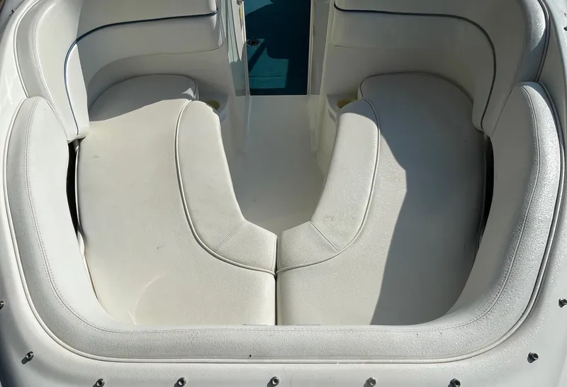 Slide: The Image of 1997 Sea Ray 190 Signature boat interior with white cushioned seating. - 8