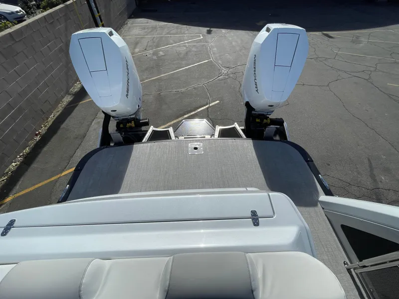 Slide: The Image of 2025 Avalon 2785 Excalibur Elite with dual outboard motors, viewed from the rear. - 13