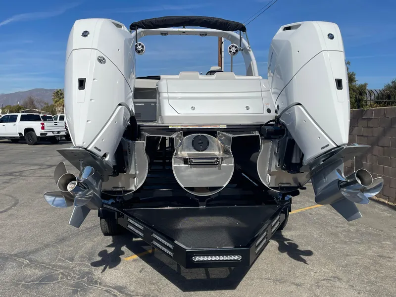 Slide: The Image of 2025 Avalon 2785 Excalibur Elite-Carbon Fiber boat, rear view with dual engines. - 4