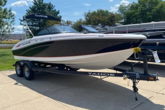 Slide: The Image of 2023 Tahoe 210 Si boat on a trailer, displayed outdoors. - 0