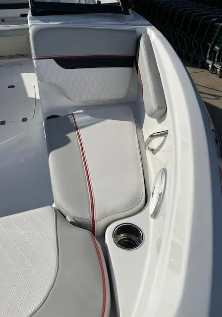 Slide: The Image of 2023 Tahoe 210 Si boat interior with white and red-trimmed seating. - 10