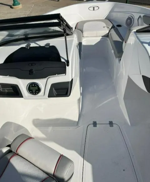 Slide: The Image of 2023 Tahoe 210 Si boat interior with sleek white design and modern dashboard. - 9