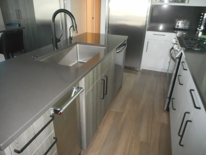 Slide: The Image of Modern kitchen with sleek countertops, stainless steel appliances, and wood flooring in Adonia Obsession Trip #12. - 26