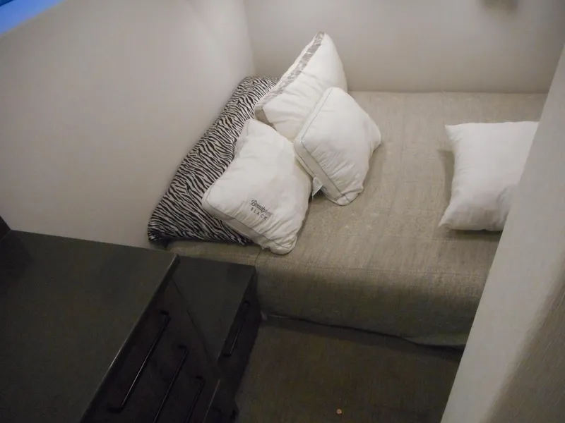 Slide: The Image of Compact bedroom with cozy bed, white pillows, and zebra-patterned pillow in Adonia Obsession Trip #12, 2021. - 30