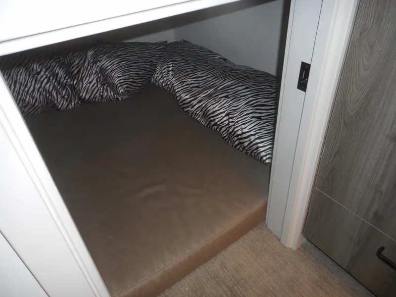 Slide: The Image of Compact sleeping area with zebra-patterned bedding in Adonia Obsession Trip #12, 2021 model. - 31