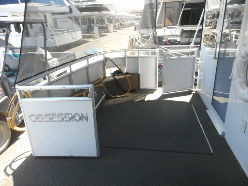 Slide: The Image of Adonia Obsession Trip #12, 2021 model, docked with open deck view and marina background. - 46