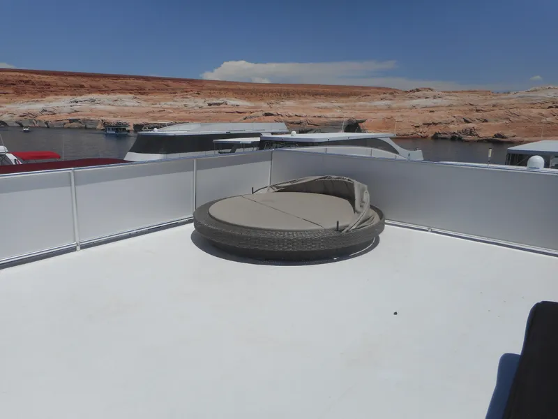 Slide: The Image of Rooftop deck of Adonia Obsession Trip #12 houseboat, featuring a round sunbed, 2021 model. - 6