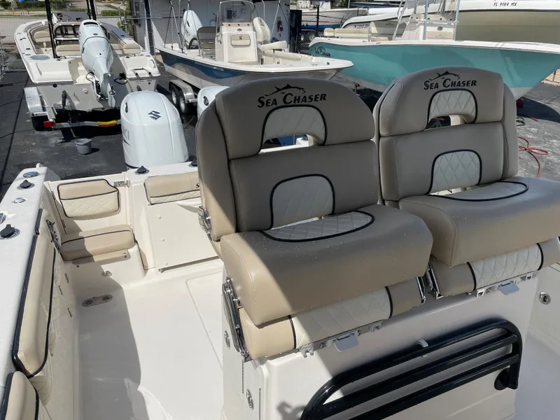 Slide: The Image of 2023 Sea Chaser 27 HFC boat interior with dual seats and spacious deck. - 11