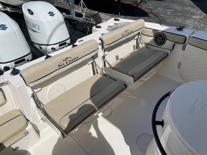 Slide: The Image of 2023 Sea Chaser 27 HFC boat with beige seating and Suzuki outboard motors. - 13