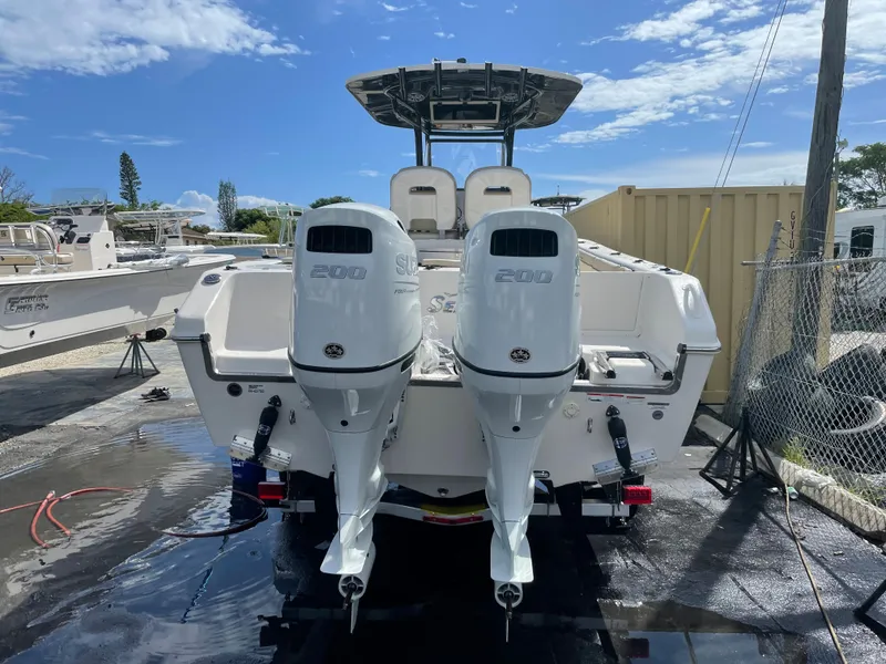 Slide: The Image of 2023 Sea Chaser 27 HFC boat with twin 200 HP engines, docked and ready. - 17