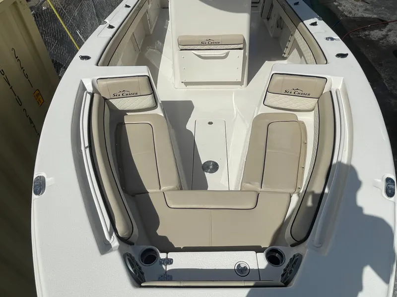 Slide: The Image of 2023 Sea Chaser 27 HFC boat interior with beige seating and cup holders. - 3