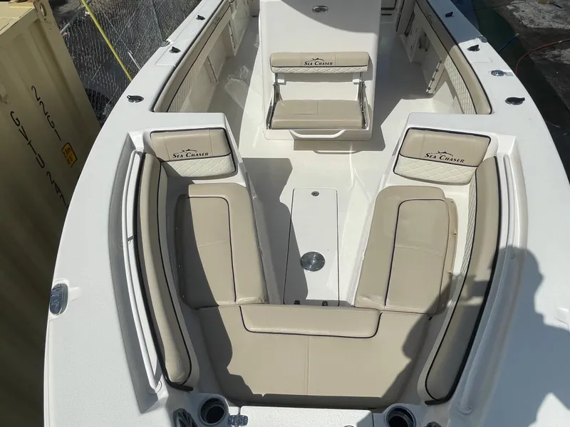Slide: The Image of 2023 Sea Chaser 27 HFC boat interior with beige seating and white deck. - 4