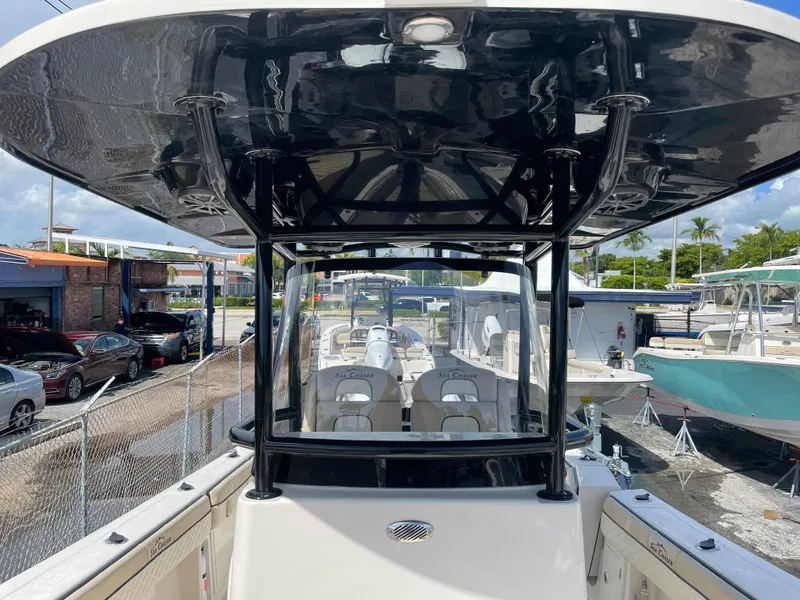 Slide: The Image of 2023 Sea Chaser 27 HFC boat with T-top and seating, docked at marina. - 8