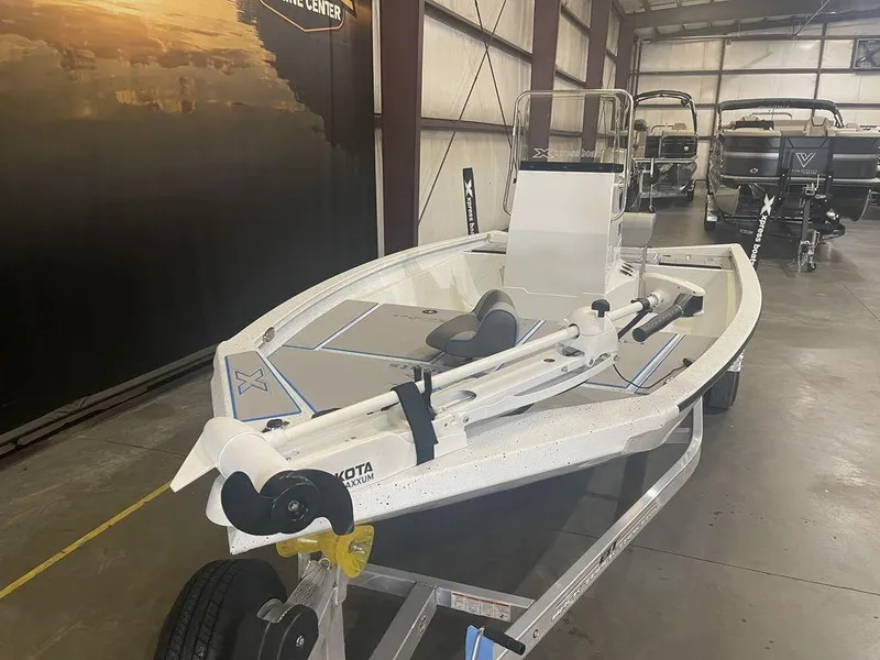 Slide: The Image of 2023 Xpress H190B boat on display in a showroom. - 10