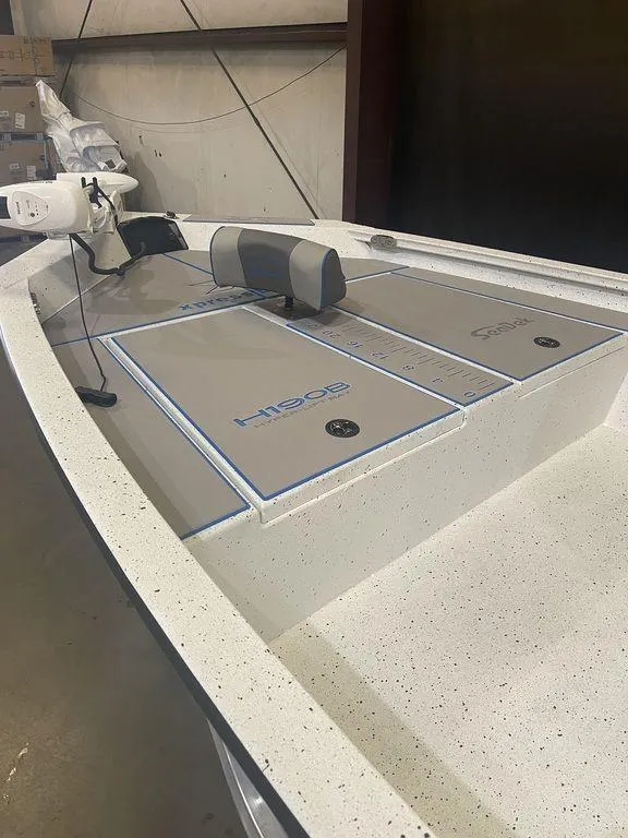 Slide: The Image of 2023 Xpress H190B boat interior with storage compartments and seating. - 12