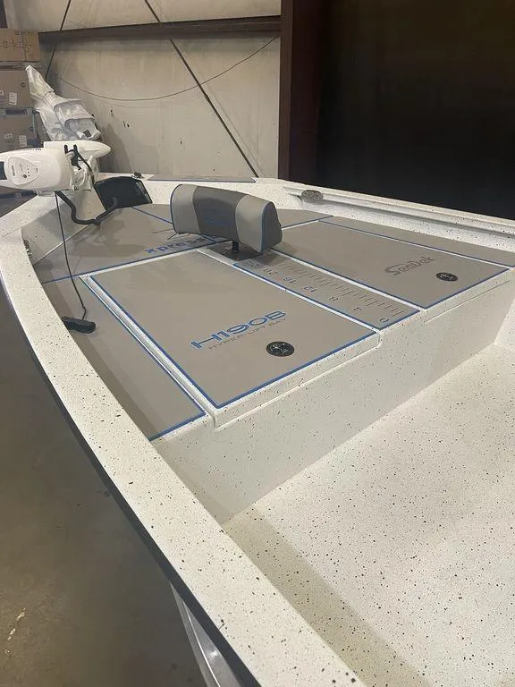 Slide: The Image of 2023 Xpress H190B boat interior with storage compartments and seating. - 13