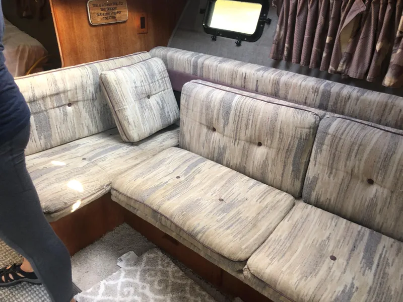 Slide: The Image of Interior seating area of 1986 Cruisers ESPRIT 3370 boat with striped cushions. - 12