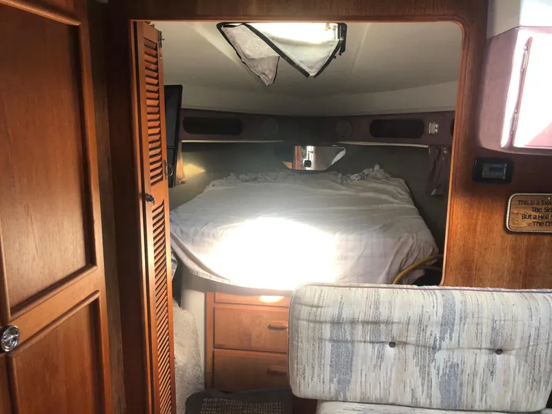 Slide: The Image of Interior cabin of 1986 Cruisers ESPRIT 3370 with bed and wooden furnishings. - 11