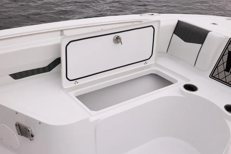 Slide: The Image of 2023 Wellcraft 222 Fisherman boat storage compartment with open lid, showcasing interior space. - 14