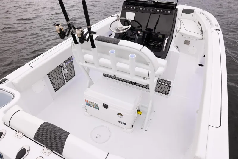 Slide: The Image of 2023 Wellcraft 222 Fisherman boat interior with fishing rod holders and steering console. - 16