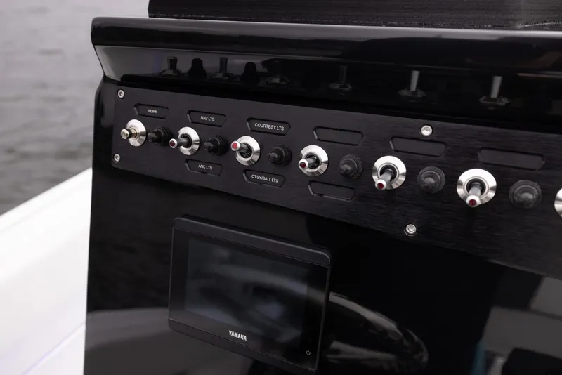 Slide: The Image of Control panel of 2023 Wellcraft 222 Fisherman boat with switches and display. - 19