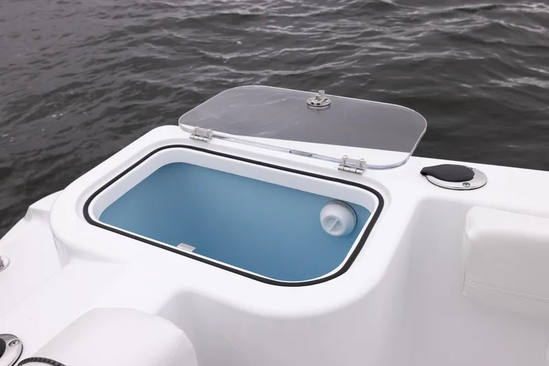 Slide: The Image of 2023 Wellcraft 222 Fisherman boat livewell with open lid on water. - 21