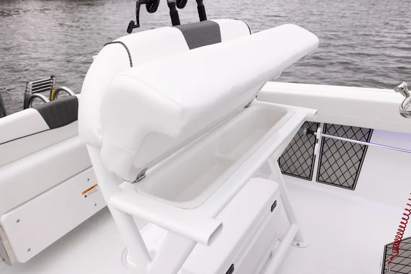 Slide: The Image of 2023 Wellcraft 222 Fisherman boat interior with white seating and storage compartment. - 23