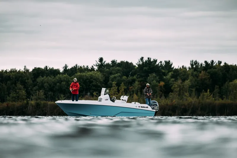 Slide: The Image of 2023 Wellcraft 222 Fisherman boat on a lake with two people fishing. - 7