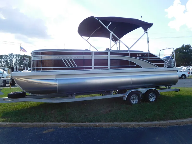 Slide: The Image of 2023 Bennington 22 LSB pontoon boat on a trailer with a canopy. - 1