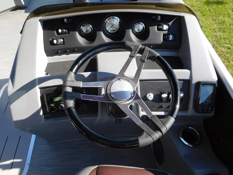 Slide: The Image of 2023 Bennington 22 LSB boat dashboard with steering wheel and gauges. - 2