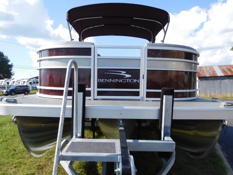 Slide: The Image of 2023 Bennington 22 LSB pontoon boat, front view, docked on trailer. - 4