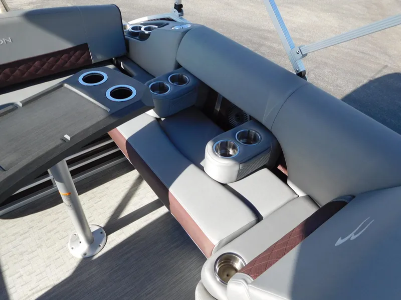 Slide: The Image of 2023 Bennington 22 LSB boat interior with cushioned seating and multiple cup holders. - 6
