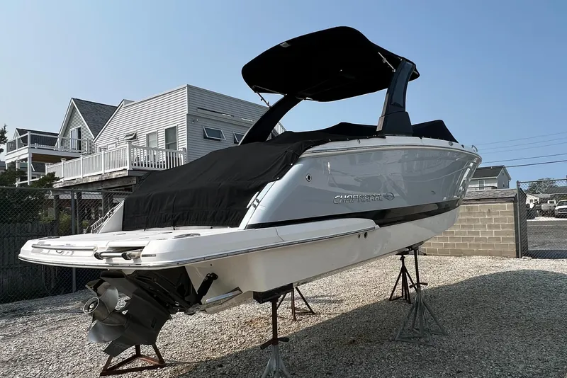 Slide: The Image of 2019 Chaparral 277 SSX boat on stands, covered, near coastal homes. - 4