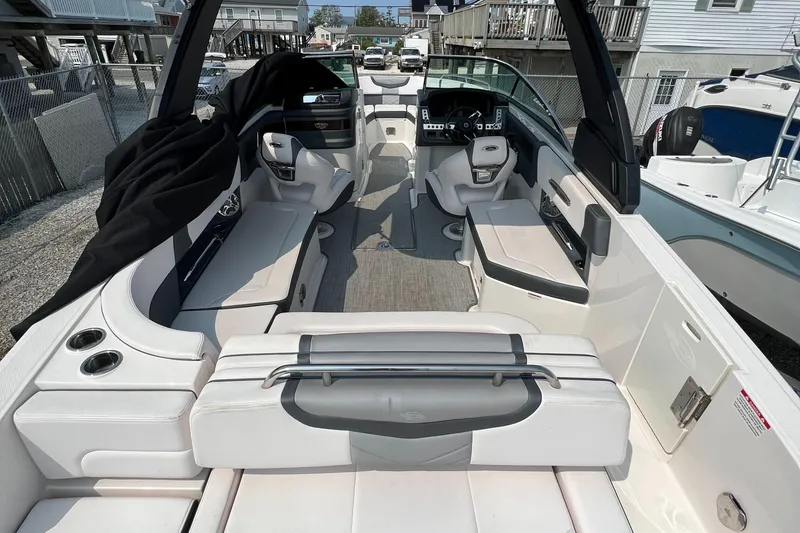 Slide: The Image of 2019 Chaparral 277 SSX boat interior with white seating and modern dashboard. - 5