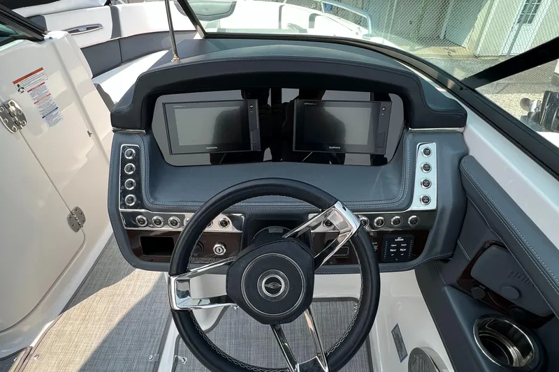 Slide: The Image of 2019 Chaparral 277 SSX boat dashboard with dual displays and modern steering wheel. - 7