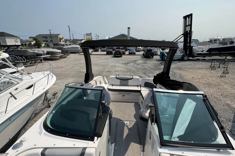 Slide: The Image of 2019 Chaparral 277 SSX boat in a marina, surrounded by other vessels. - 9