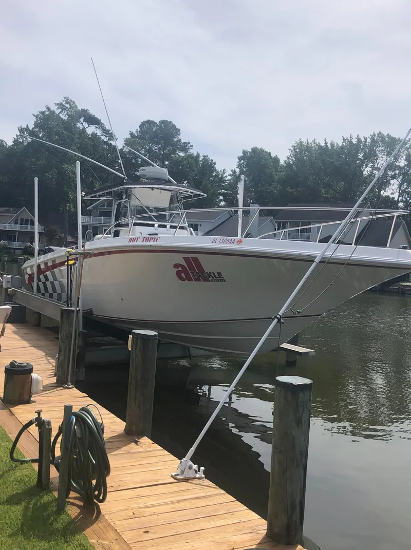 Slide: The Image of 2003 Fountain 38TE boat docked at a marina. - 10