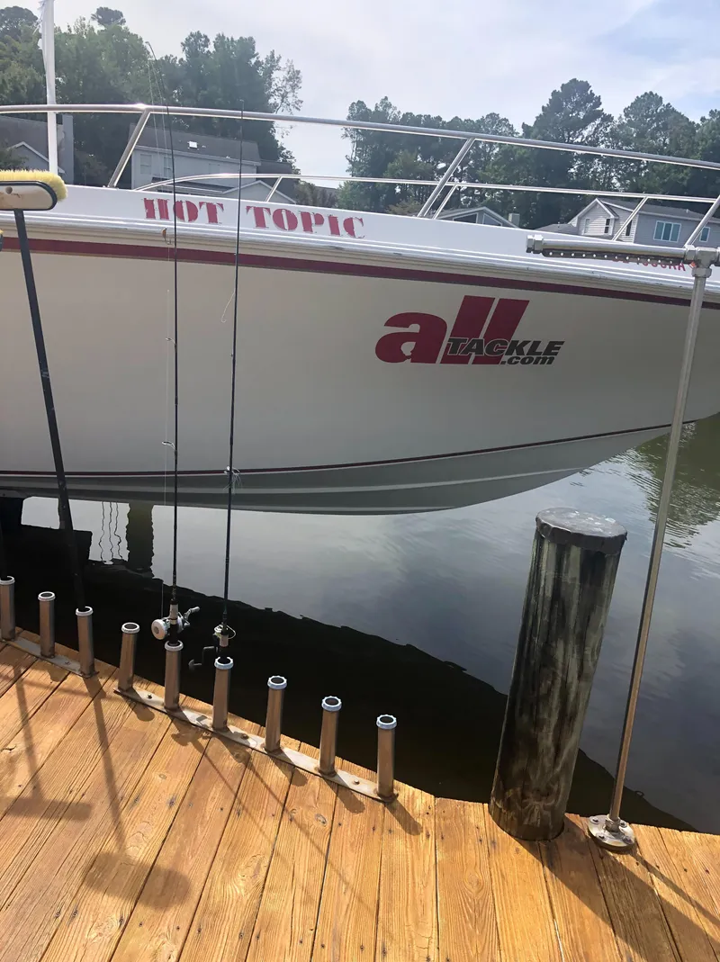 Slide: The Image of 2003 Fountain 38TE boat docked by wooden pier. - 11