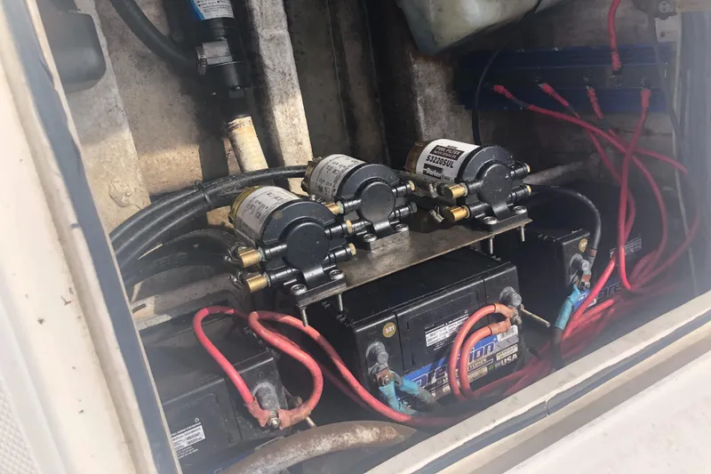 Slide: The Image of 2003 Fountain 38TE boat engine compartment with batteries and wiring. - 12