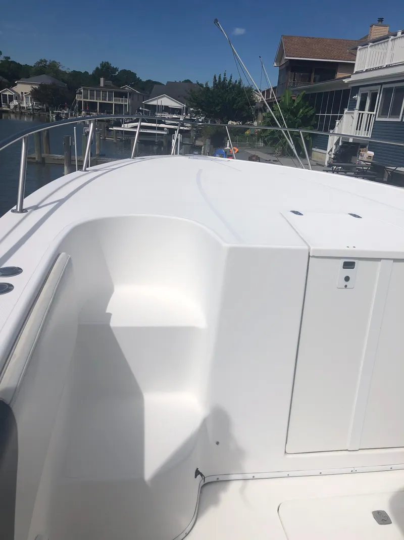 Slide: The Image of 2003 Fountain 38TE boat docked near waterfront homes. - 14