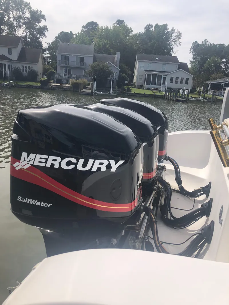 Slide: The Image of 2003 Fountain 38TE boat with triple Mercury SaltWater outboard engines. - 16