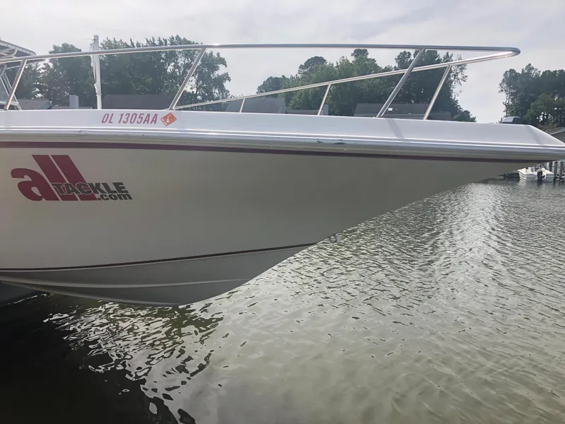 Slide: The Image of 2003 Fountain 38TE boat docked on a calm lake. - 2