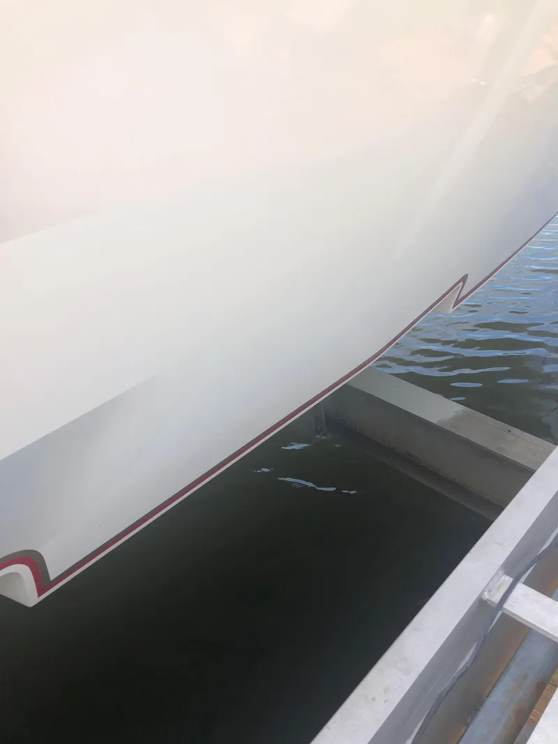 Slide: The Image of Close-up of a 2003 Fountain 38TE boat hull in water. - 6