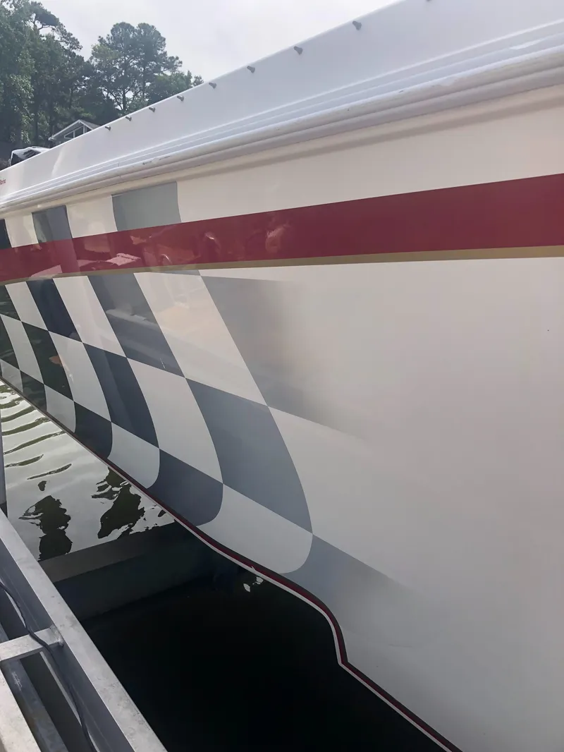Slide: The Image of 2003 Fountain 38TE boat with checkered flag design and red stripe. - 8